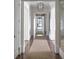 Bright hallway with hardwood floors and a neutral color palette at 923 Little Darby Ln, Suwanee, GA 30024