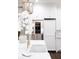 Bright kitchen featuring white cabinetry, marble countertops, and built-in refrigerator at 923 Little Darby Ln, Suwanee, GA 30024