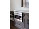 Gourmet kitchen featuring stainless steel built-in microwave and modern cabinetry at 923 Little Darby Ln, Suwanee, GA 30024