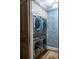 Efficient laundry room with stacked washer and dryer, maximizing space and convenience at 923 Little Darby Ln, Suwanee, GA 30024