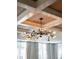 A unique sputnik-style chandelier with a wood coffered ceiling, illuminating the room with modern elegance at 923 Little Darby Ln, Suwanee, GA 30024