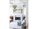 Living room with a decorative fireplace, chandelier, and natural light at 923 Little Darby Ln, Suwanee, GA 30024