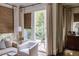 Elegant living space featuring neutral tones, a large window, and natural woven shades at 923 Little Darby Ln, Suwanee, GA 30024