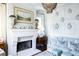 Living room with light blue walls and fireplace at 923 Little Darby Ln, Suwanee, GA 30024