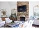 Cozy living room featuring a stone fireplace and hearth plus comfortable seating at 923 Little Darby Ln, Suwanee, GA 30024