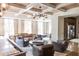 A stylish living room with a coffered wood ceiling, modern lighting, and comfortable seating arrangement at 923 Little Darby Ln, Suwanee, GA 30024