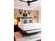 Main bedroom boasts textured wallpaper, mounted sconces, and a luxurious platform bed at 923 Little Darby Ln, Suwanee, GA 30024