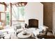 Inviting covered outdoor space with brick fireplace, stone floors and comfortable seating at 923 Little Darby Ln, Suwanee, GA 30024