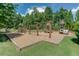 Wooden playground with swings, slides, and climbing structures at 923 Little Darby Ln, Suwanee, GA 30024