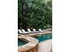 Relaxing pool with stone coping and surrounding landscaping at 923 Little Darby Ln, Suwanee, GA 30024