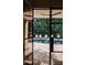 View of pool with lounge chairs through modern glass doors and black trim at 923 Little Darby Ln, Suwanee, GA 30024