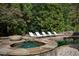 Luxurious outdoor living space with a pool, spa, fire pit and lounge chairs at 923 Little Darby Ln, Suwanee, GA 30024