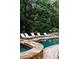 Relaxing backyard pool area with lounge chairs and lush landscaping at 923 Little Darby Ln, Suwanee, GA 30024