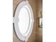 Close-up of a porthole window with white trim, set against wallpapered walls at 923 Little Darby Ln, Suwanee, GA 30024