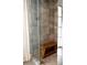 Modern shower with glass door, a wooden bench, and stone tile at 923 Little Darby Ln, Suwanee, GA 30024