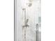 Spa-like shower with marble tiles and modern fixtures with glass door at 923 Little Darby Ln, Suwanee, GA 30024