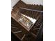 Elegant dark wood staircase with modern metal railings, creating a grand and stylish entrance at 923 Little Darby Ln, Suwanee, GA 30024