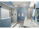 Spa-like bathroom with a glass shower, blue walls, and patterned tile floors at 107 Watson Se Cir, Atlanta, GA 30317