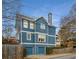 Blue house with two-car garage and mature trees at 107 Watson Se Cir, Atlanta, GA 30317