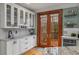 White kitchen cabinets, granite countertops, and French doors leading to a deck at 107 Watson Se Cir, Atlanta, GA 30317