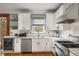 Modern kitchen with granite countertops, stainless steel appliances, and white cabinets at 107 Watson Se Cir, Atlanta, GA 30317