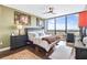 Spacious bedroom with city view, hardwood floors, and ceiling fan at 1280 W Peachtree Nw St # 3902, Atlanta, GA 30309