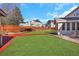 Landscaped backyard with sunroom and wooden fence at 1943 Ivy Branch Ct, Loganville, GA 30052