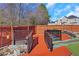 Backyard patio with red surface and wooden bridge at 1943 Ivy Branch Ct, Loganville, GA 30052