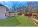 Large backyard with green grass and wooden bridge at 1943 Ivy Branch Ct, Loganville, GA 30052