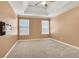 Large bedroom with neutral carpet and tray ceiling at 1943 Ivy Branch Ct, Loganville, GA 30052