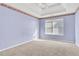 Bright bedroom with lavender walls and carpet at 1943 Ivy Branch Ct, Loganville, GA 30052