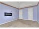 Bedroom with lavender walls, carpet, and built-in fireplace at 1943 Ivy Branch Ct, Loganville, GA 30052