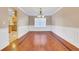 Bright dining room with hardwood floors and wainscoting at 1943 Ivy Branch Ct, Loganville, GA 30052