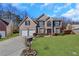 Brick two-story house with a two-car garage and landscaped lawn at 1943 Ivy Branch Ct, Loganville, GA 30052