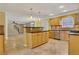 Kitchen with light wood cabinets, granite counters, and tile floor at 1943 Ivy Branch Ct, Loganville, GA 30052