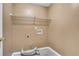 Bright laundry room with shelving and tile floor at 1943 Ivy Branch Ct, Loganville, GA 30052