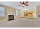 Spacious living room with fireplace and view of kitchen at 1943 Ivy Branch Ct, Loganville, GA 30052