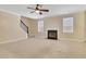 Living room with fireplace and neutral carpeting at 1943 Ivy Branch Ct, Loganville, GA 30052