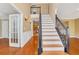 Elegant staircase with wrought iron railing and hardwood floors at 1943 Ivy Branch Ct, Loganville, GA 30052