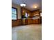 Retro kitchen with wood cabinets and laminate floors at 3265 Heard Drive, Cumming, GA 30040