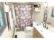 Updated bathroom with a floral shower curtain, modern vanity, and marble-look flooring at 34 Timber Chase Dr, Dallas, GA 30157