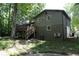 Back exterior view of house with deck and large trees at 34 Timber Chase Dr, Dallas, GA 30157