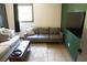 Modern living room featuring gray sofas, wood flooring, and a green accent wall at 34 Timber Chase Dr, Dallas, GA 30157