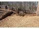 Backyard with a fire pit area surrounded by a wooden fence and mature trees, perfect for gatherings at 753 Win West Xing, Auburn, GA 30011