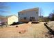 Backyard featuring a wooden deck, sloped dry lawn, and a two-story home at 753 Win West Xing, Auburn, GA 30011