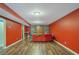 Finished basement with red walls, a comfortable couch, and lots of books at 753 Win West Xing, Auburn, GA 30011