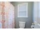 Updated bathroom with modern toilet, contemporary shower curtain, and window at 753 Win West Xing, Auburn, GA 30011