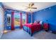 Vibrant bedroom design showcasing red curtains, string lights and blue walls at 753 Win West Xing, Auburn, GA 30011