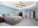 Large primary bedroom showcasing a tray ceiling, bright walls, and carpet flooring at 753 Win West Xing, Auburn, GA 30011