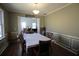 Inviting dining room with wainscoting, hardwood floors, and a view into the living room at 753 Win West Xing, Auburn, GA 30011